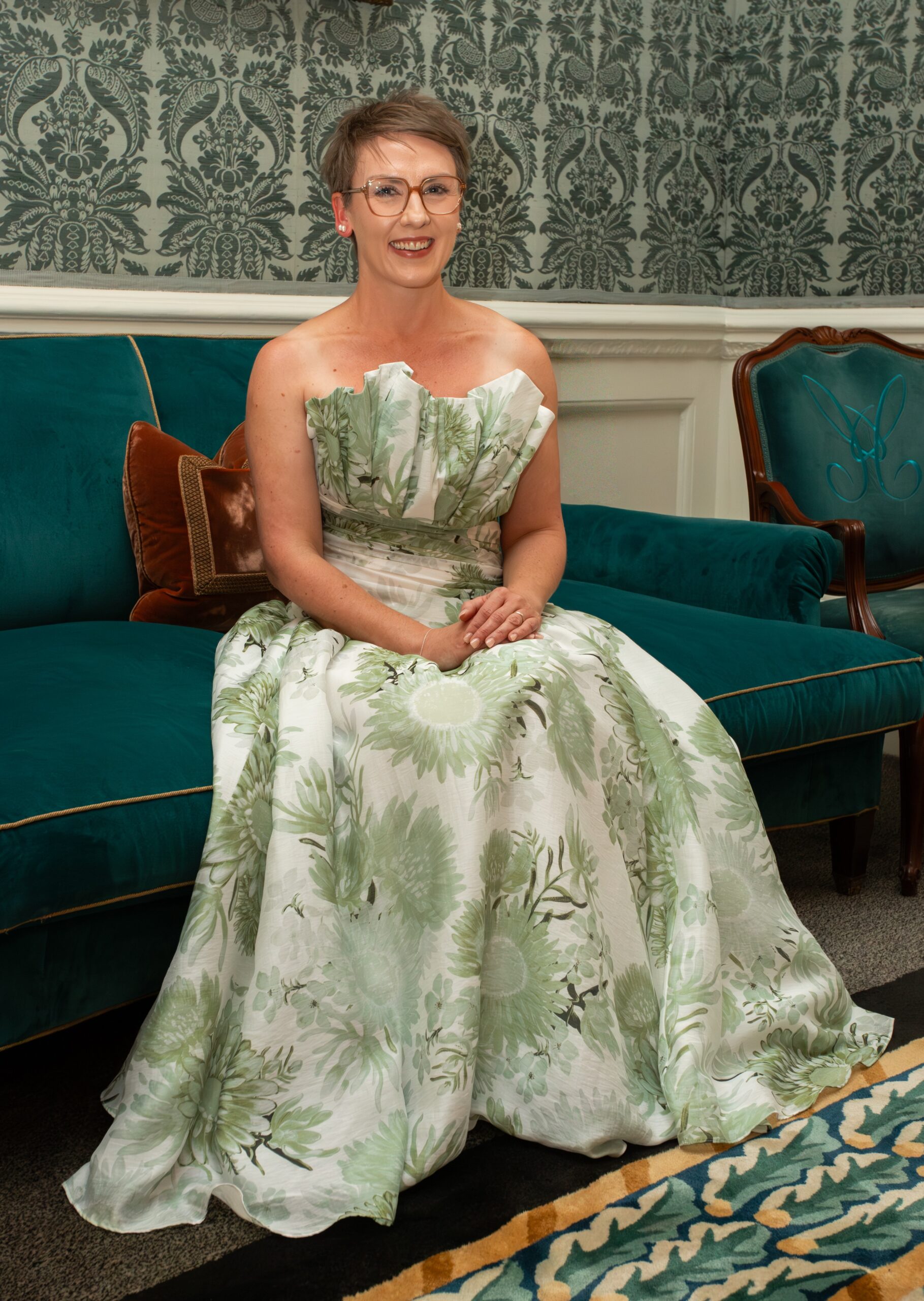 An etiquette coach seated in an elegant London drawing room