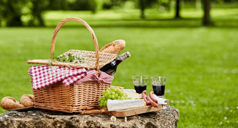 Close Up Of Picnic Party In The Park Drink Table With Large